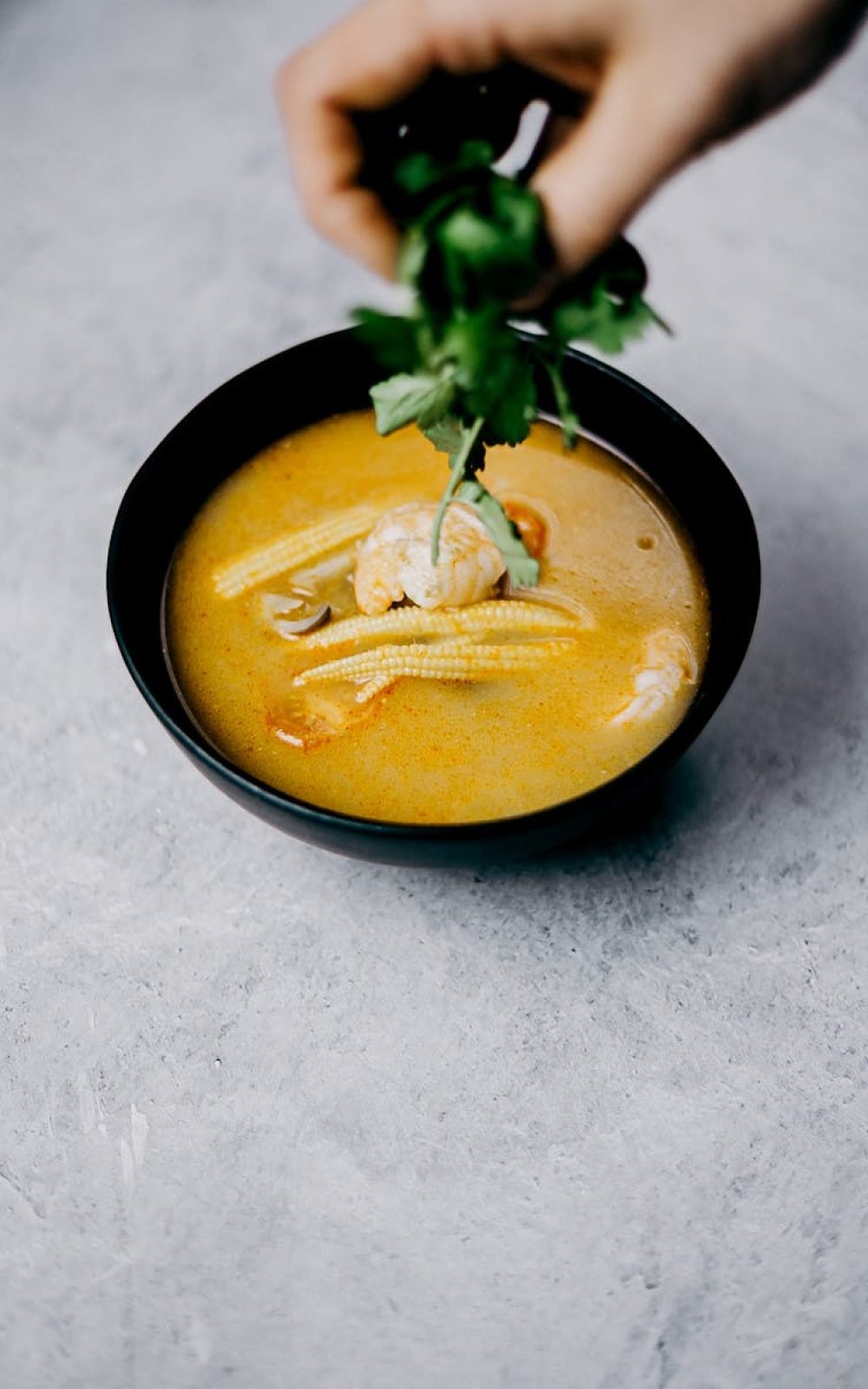 Savor this flavorful shrimp soup with baby corn and cilantro, perfect for Asian cuisine lovers.